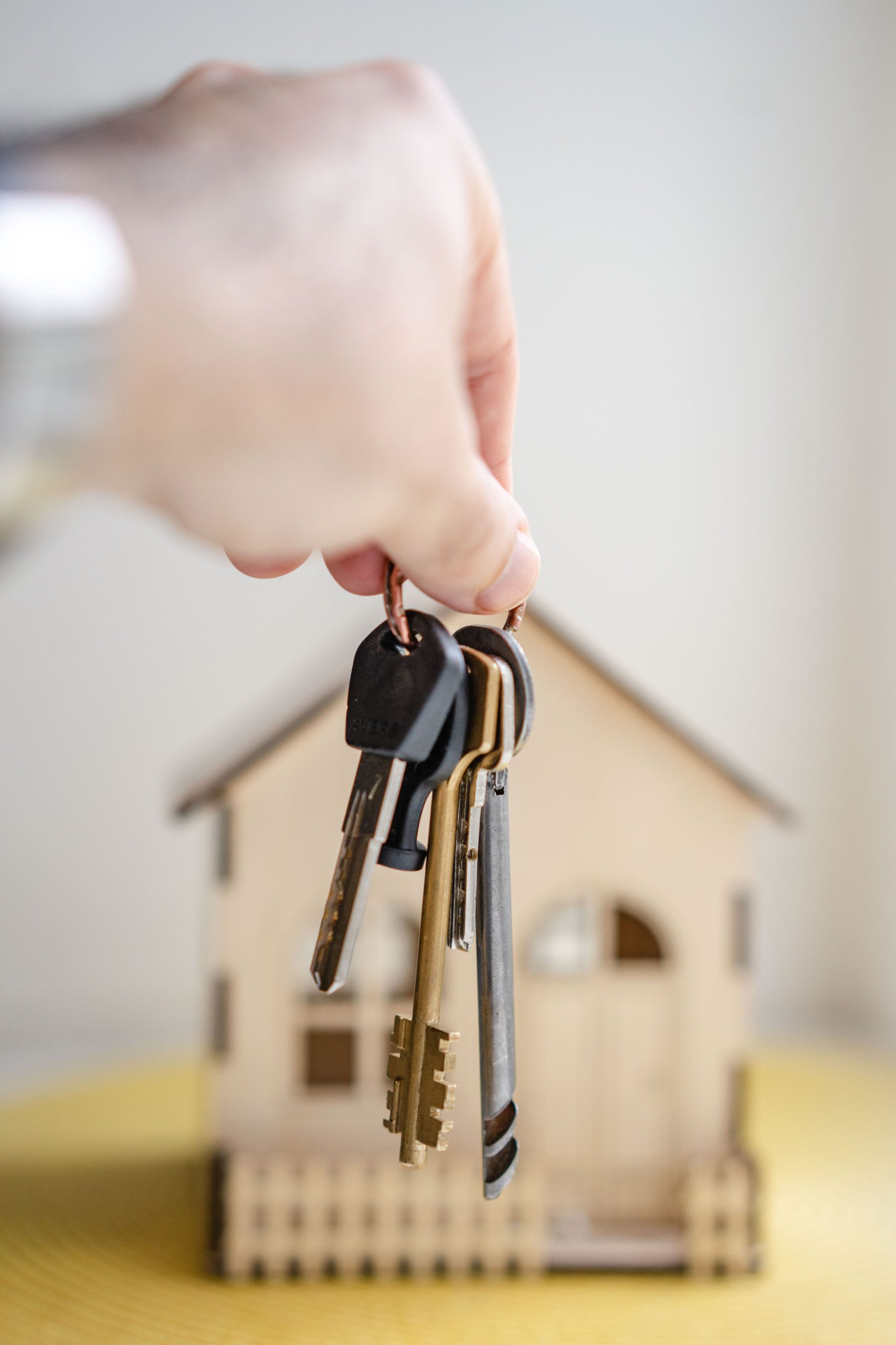 Hand holding new house keys at front door — first home buyer loans Perth